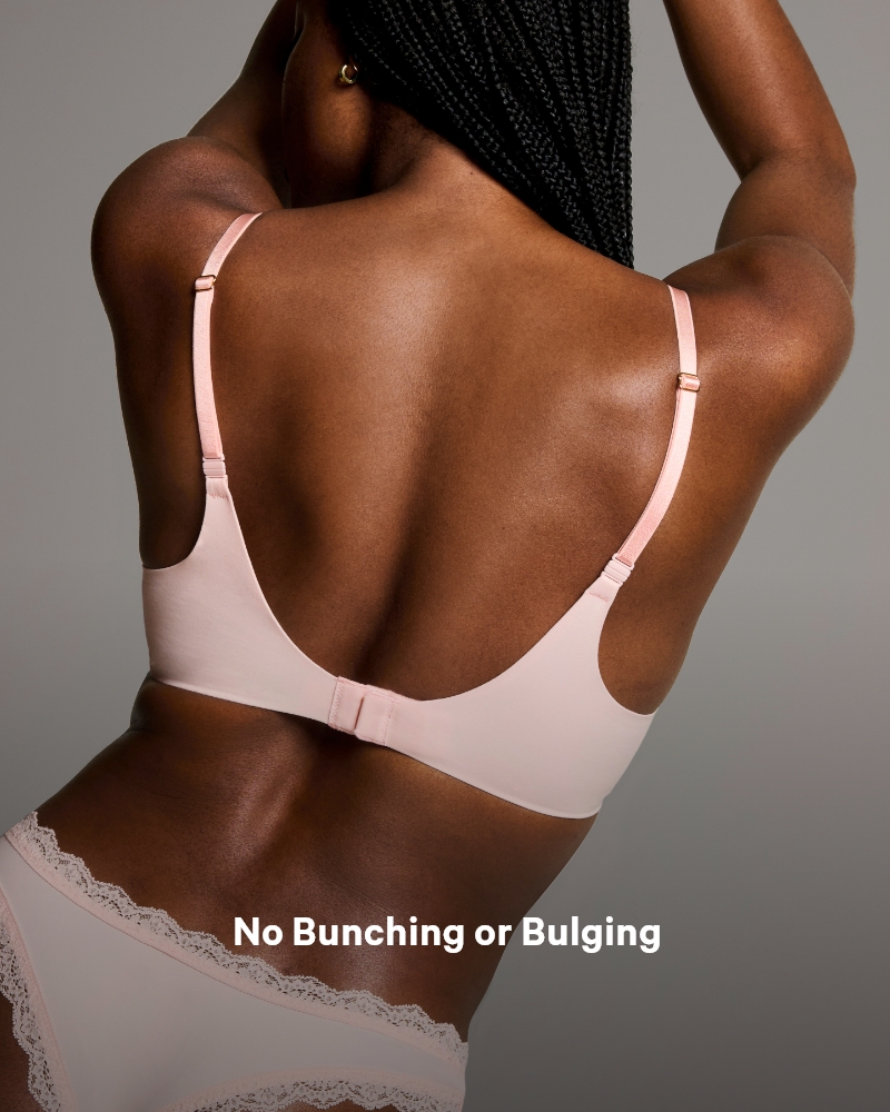 Back side of a woman posing in a baby pink a Victoria's Secret Lightly lined bra.