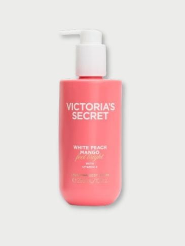 Victoria's Secret White Peach Mango Coconut Milk bottle on a light grey background 
